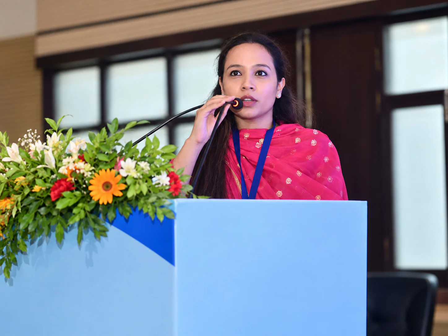 Dr Pranjali Joshi speaking at a lectern during an academic event