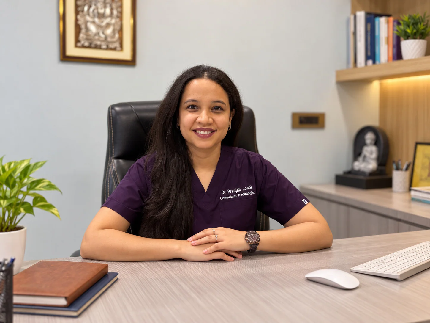 Dr. Pranjali Joshi seated at her desk in a consultation setting